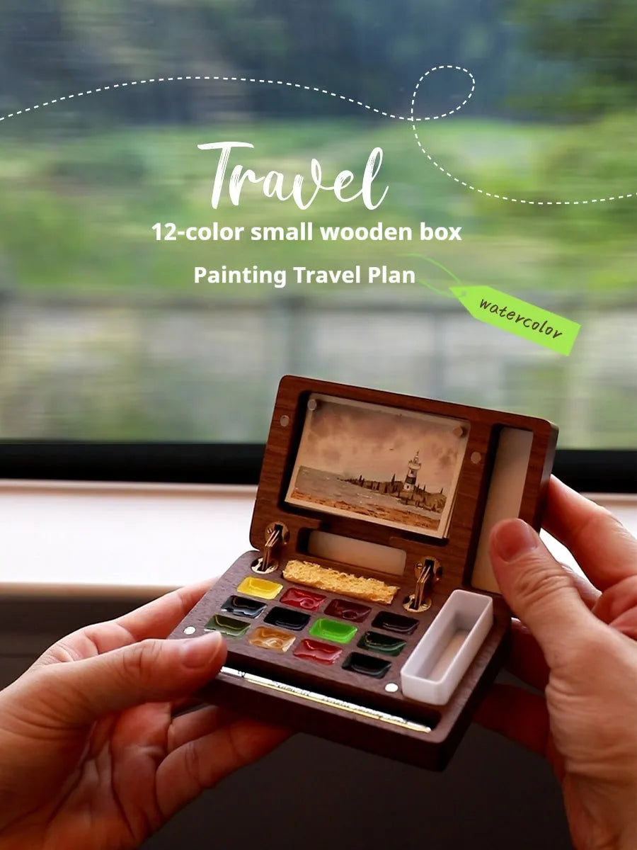 Mini walnut wood paint box open showing compartments for watercolour pigment pans.