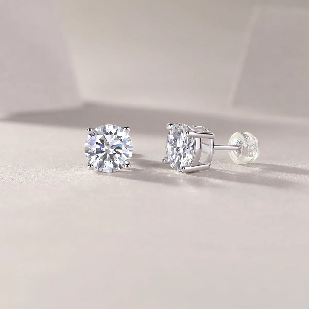 Pair of moissanite stud earrings with platinum-plated S925 silver settings, on a gift box, available in black or transparent stones
