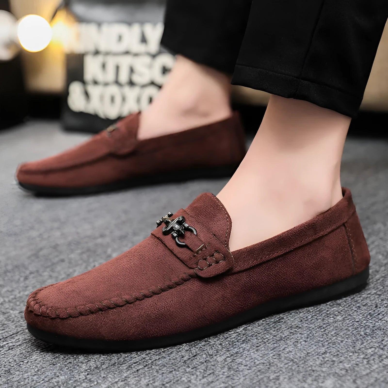Men's black slip-on loafers with round toe and low stiletto heel, showing sewing thread detailing on artificial PU leather upper