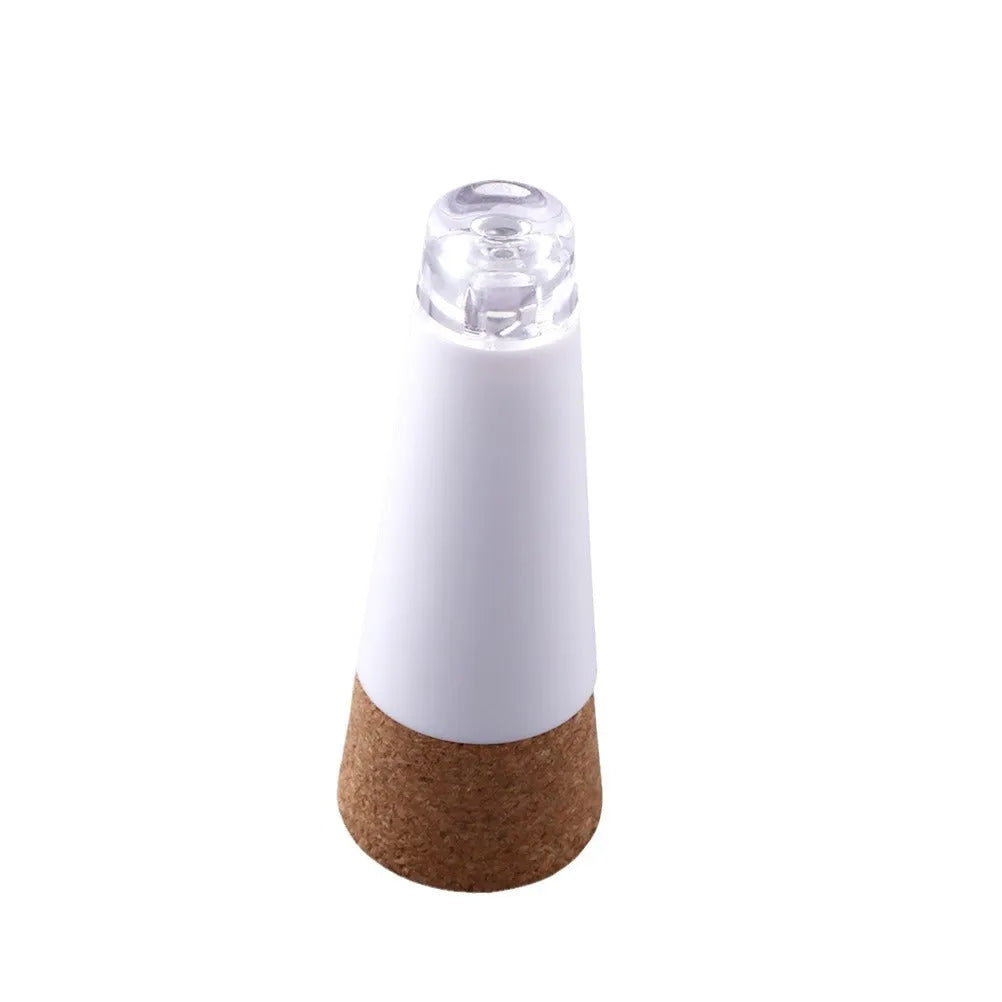 White plastic rechargeable LED bottle cap light with 15 beads, shown on a wine bottle for holiday decor.