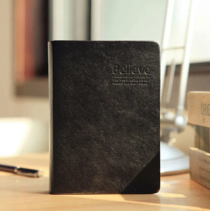 Large thick leather Phnom Penh notebook in gold, A6 size, 480 pages, open on a desk