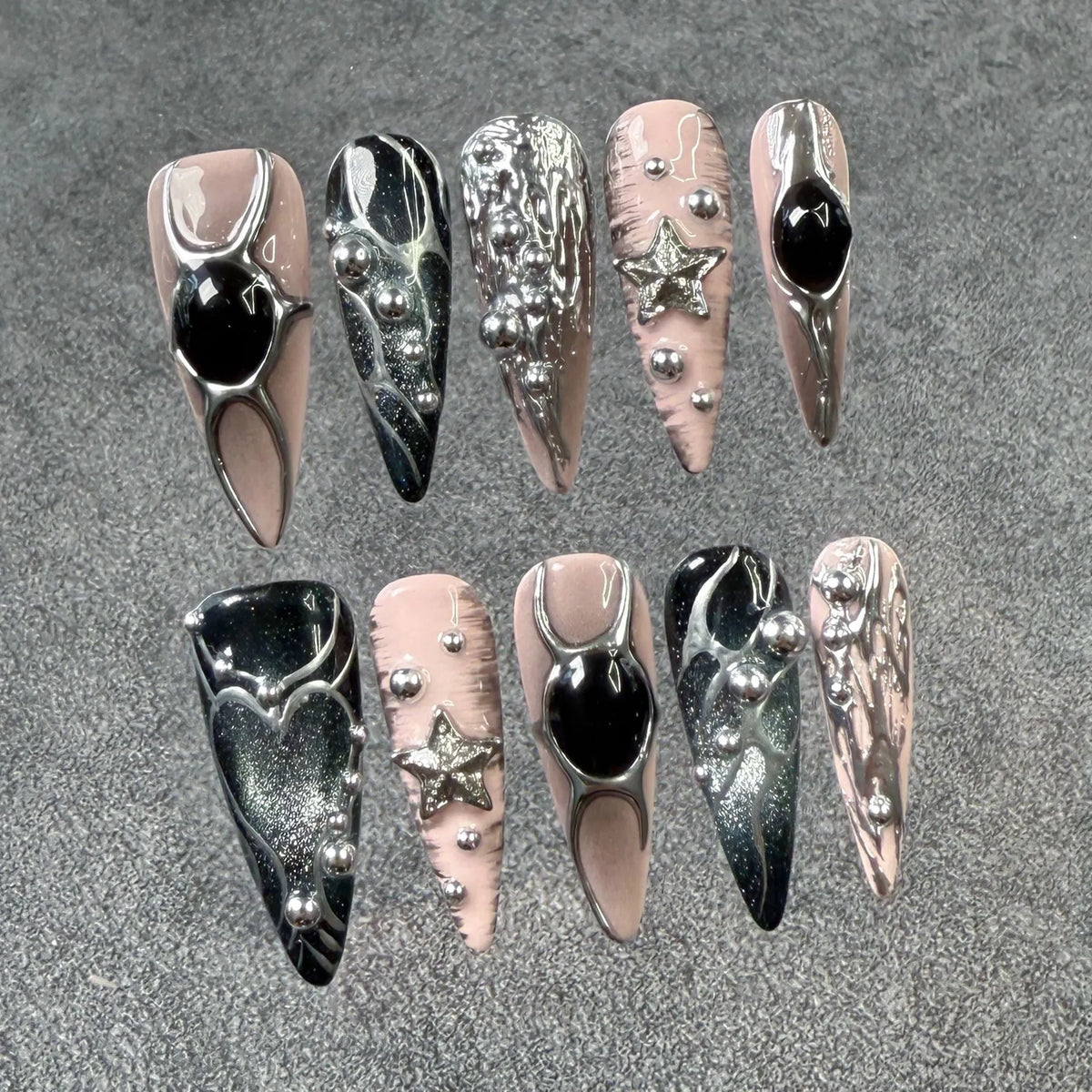 Long pointed press-on false nails with embossed relief and hand-painted metal detail in XS S M L sizes