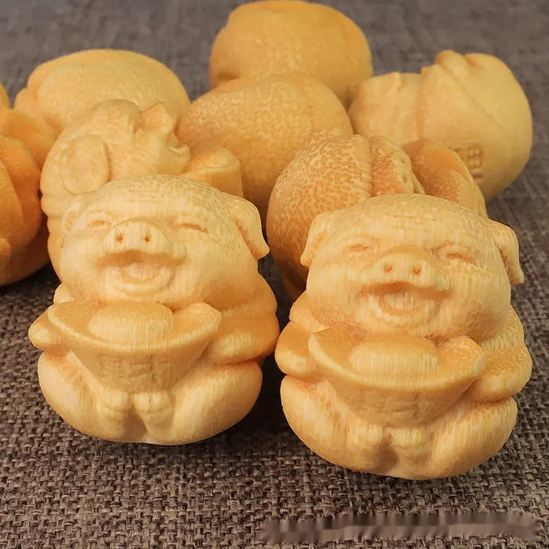 Solid bamboo carving ornament with cute pig design measuring 4cm tall by 3.5cm diameter
