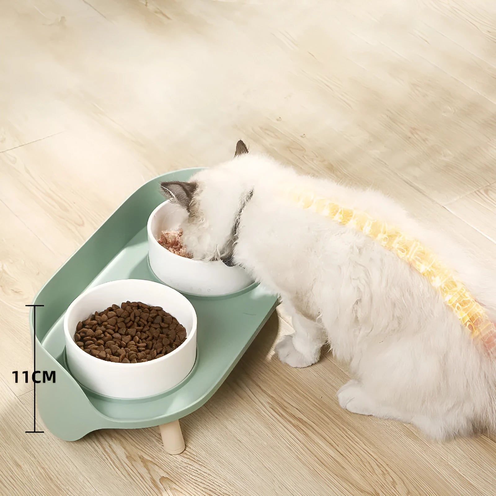 Green and white adjustable tilted pet feeding bowl with dual food and water compartments for cats and dogs