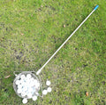 A metallic-coloured stainless steel golf ball picker or retriever tool on a green background.