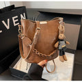 Women's retro messenger bag in PU leather, brown colour, 21x11x21 cm with pendant and double shoulder straps