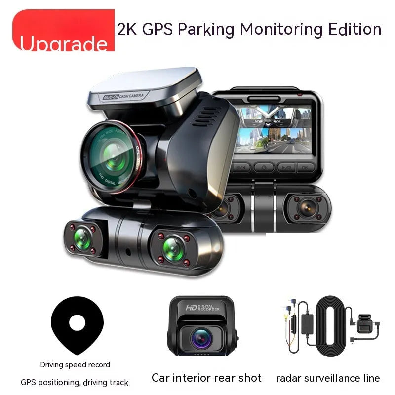 Black four-lens car dash cam with 2-inch screen mounted on a car windscreen.
