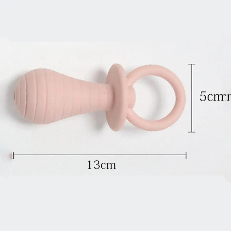 Four TPR rubber pet pacifier chew toys with squeakers in blue, grey, green, and pink colours