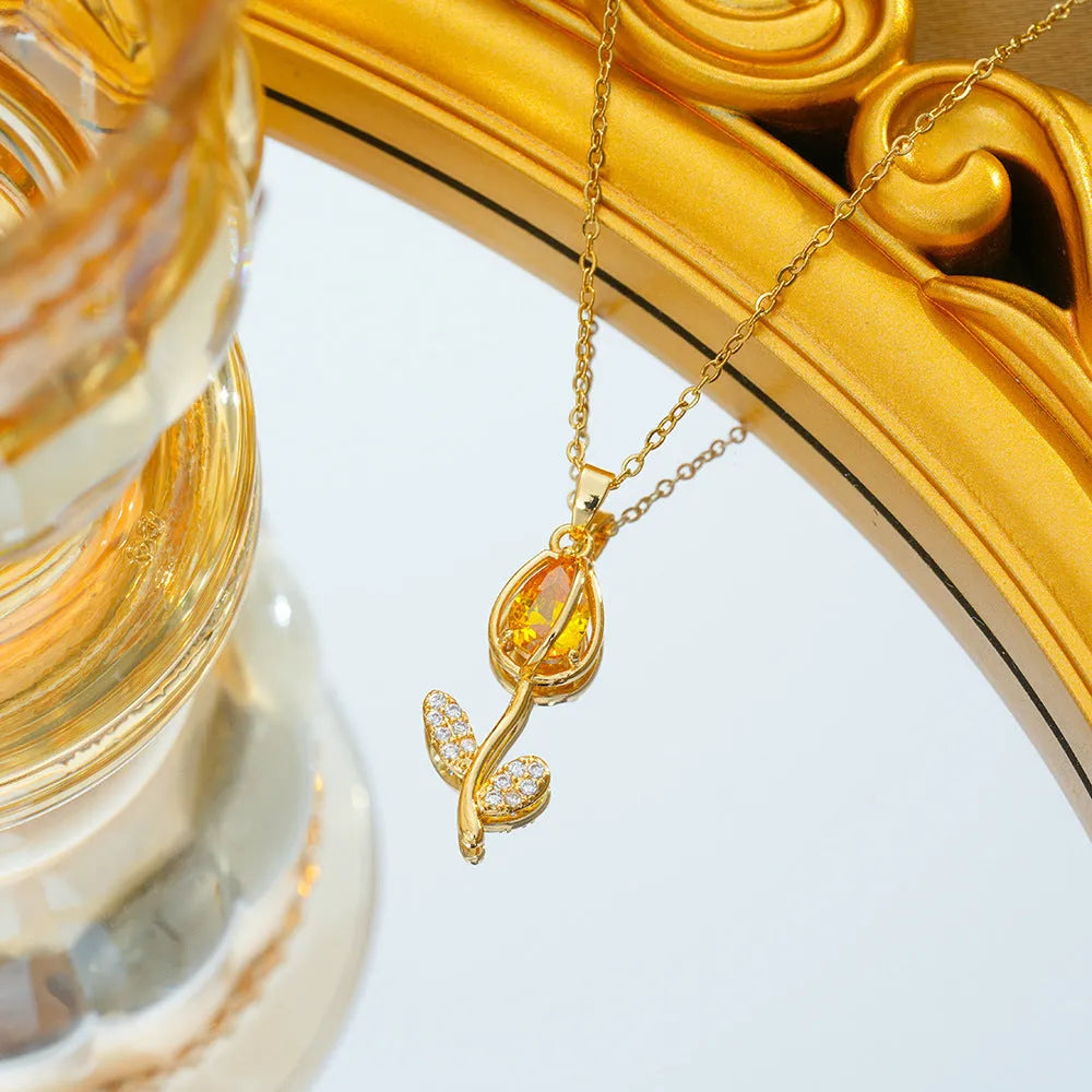 Gold tulip pendant necklace on an adjustable O-ring chain, showing non-fading electroplated finish.