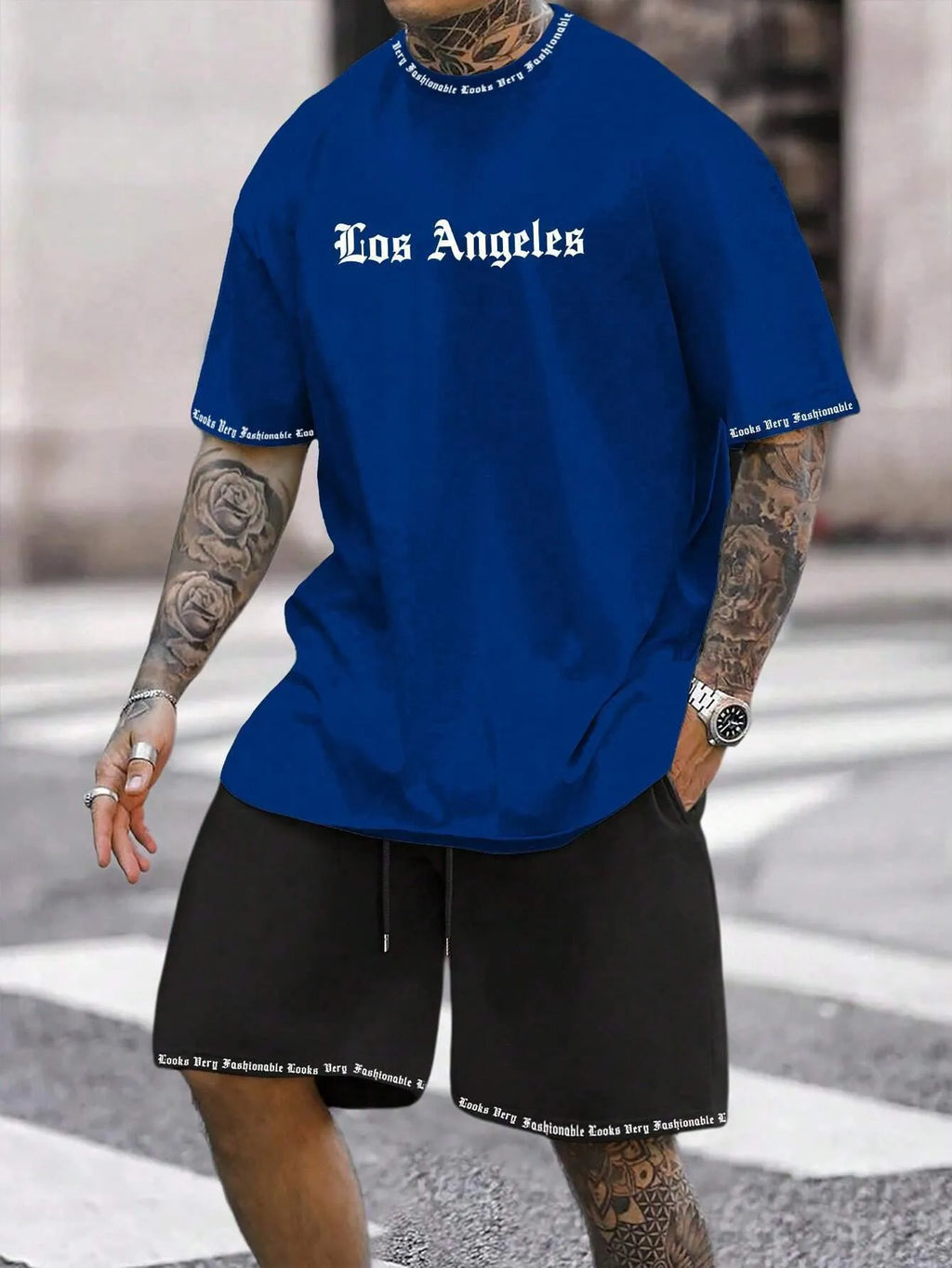 Man wearing a grey short-sleeved sports top and matching shorts from a quick-dry two-piece set.