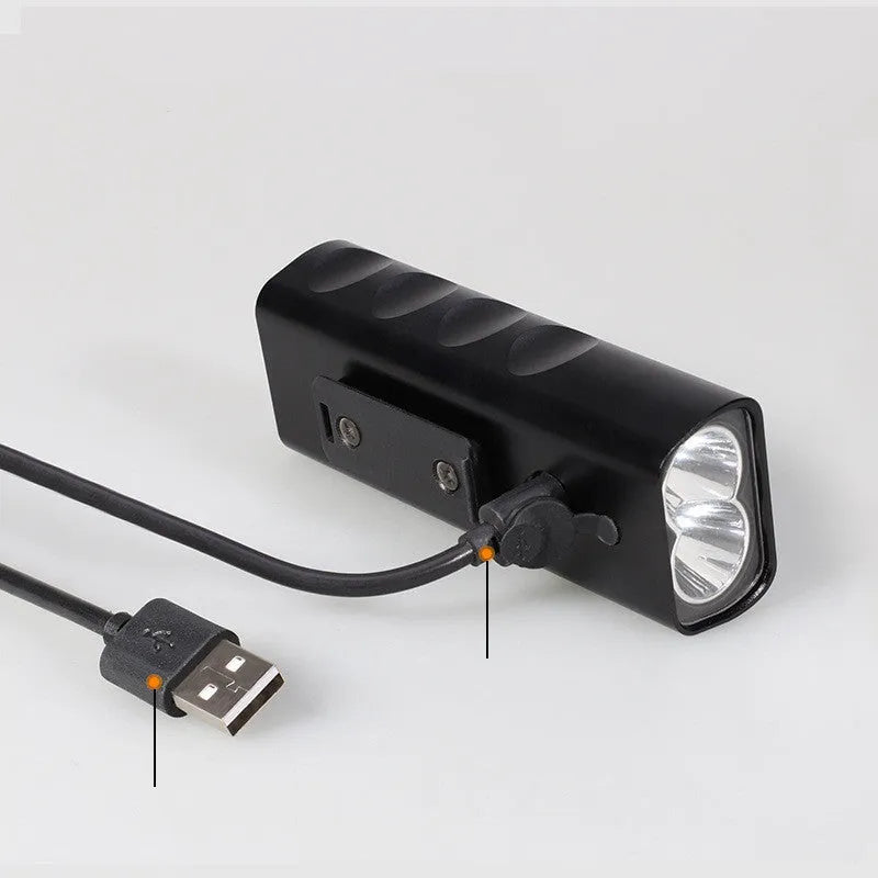 Black rechargeable bicycle headlight with aluminium alloy body and 360-degree bracket on handlebars