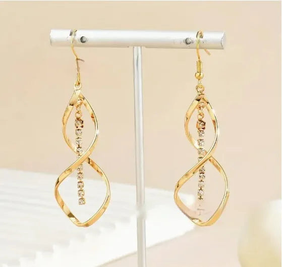 Gold geometric spiral earrings with ellipse elements and electroplated finish