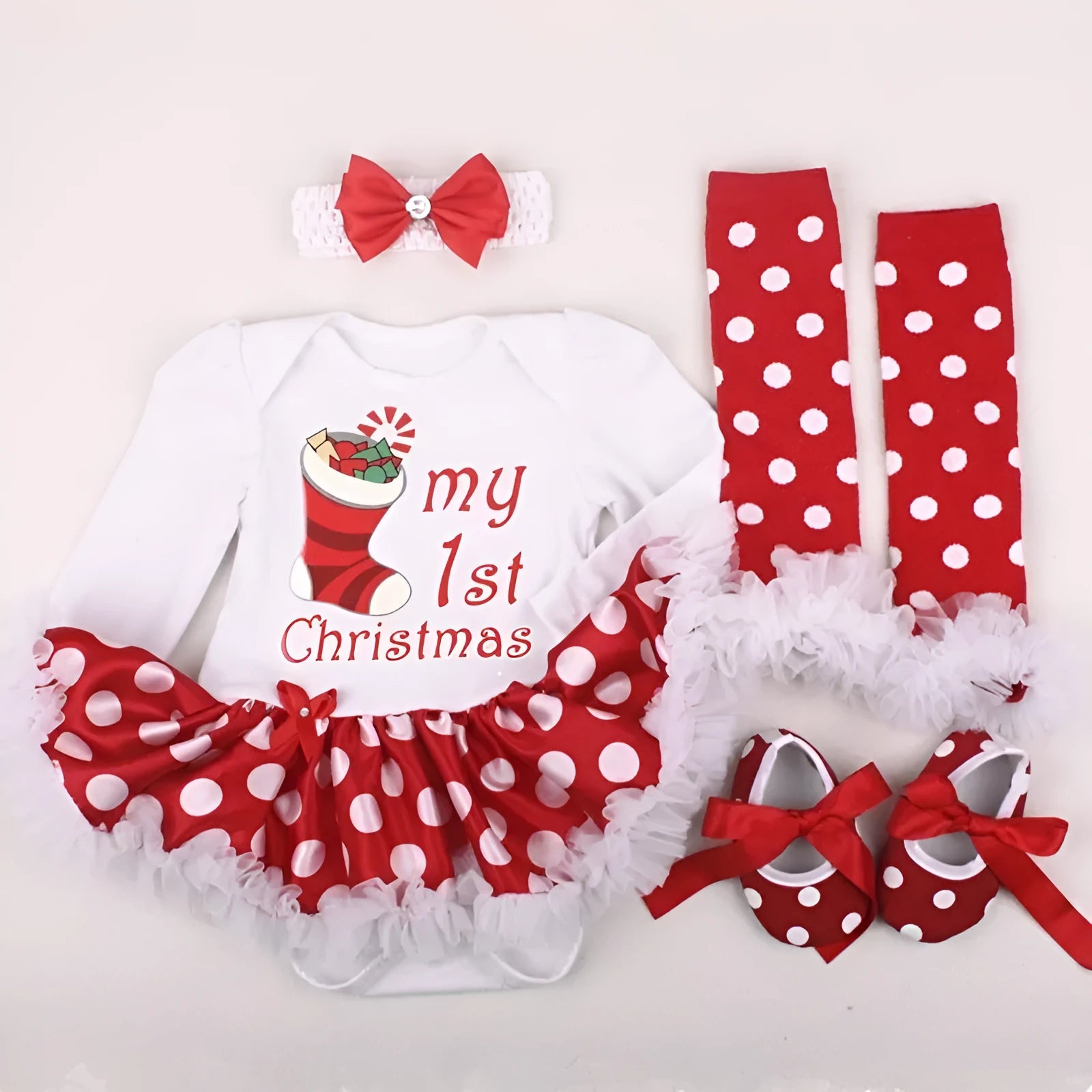 Four-piece newborn clothing set with cotton romper, headband, socks and shoes on display