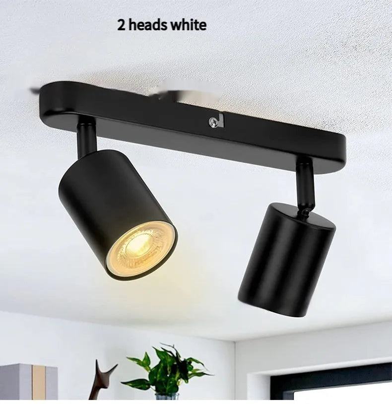 Three-head adjustable aluminium ceiling spotlight in black finish, angled for TV wall lighting