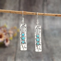 Silver geometric drop earrings with turquoise inlay detailing on long strip design