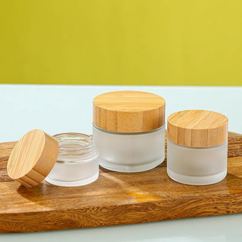 Refillable glass cream jar with bamboo wood lid, transparent finish, 100g capacity