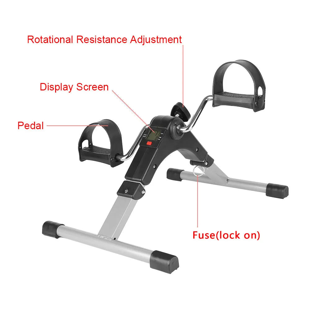 Silver and black exercise mini spinning bike on hard floor with pedals and non-slip foot pads