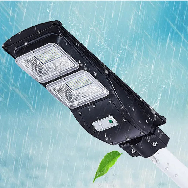 Integrated solar-powered 60W LED street light with remote control for outdoor use.