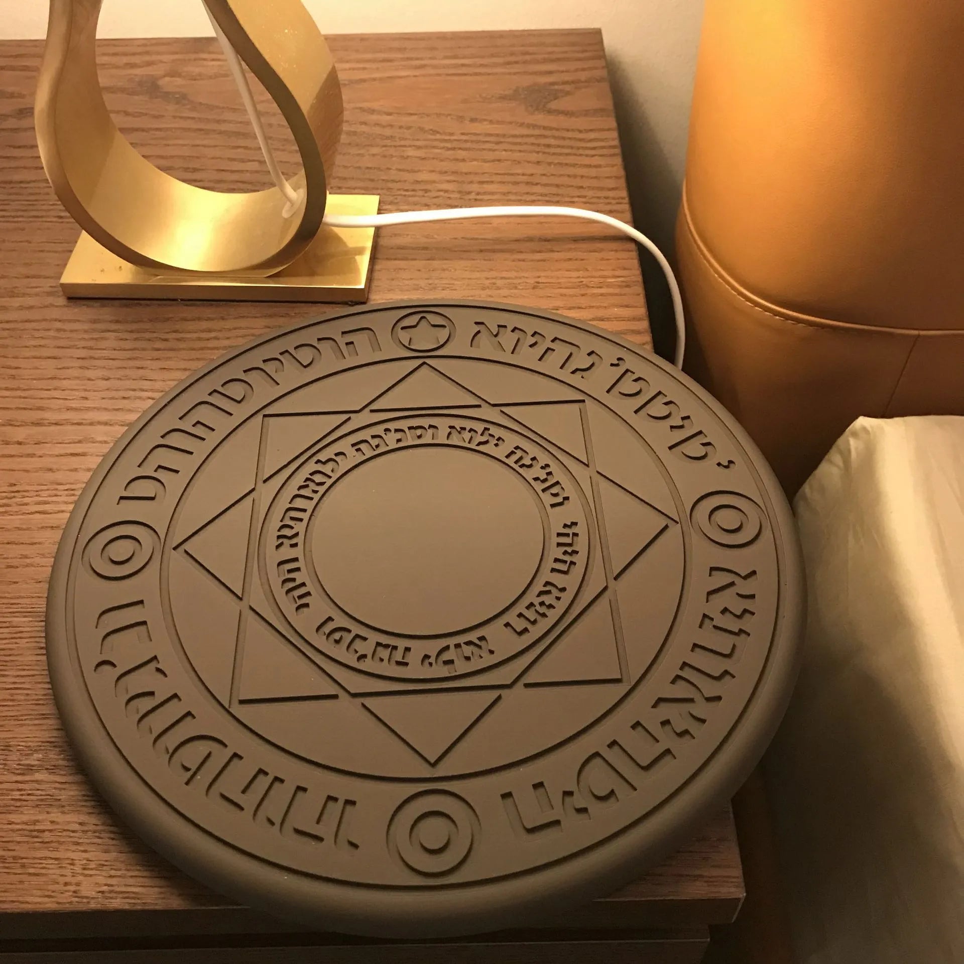 Square black 10W fast wireless charging pad with glowing magic array pattern for Qi phones.