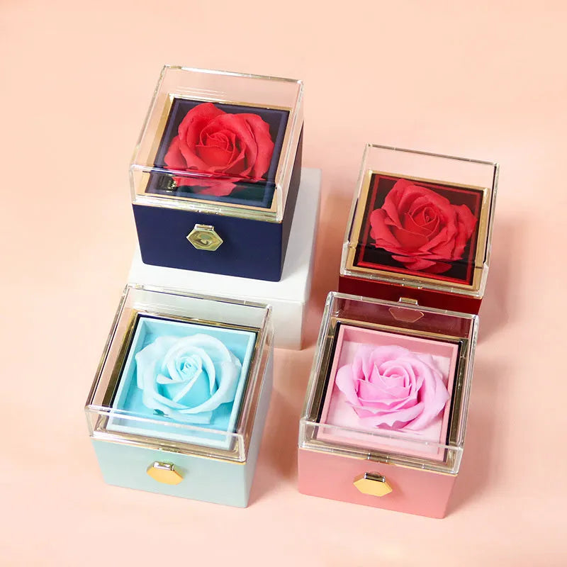 Rotating jewellery gift box with a preserved red rose under a clear acrylic dome.