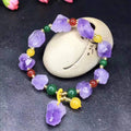 Women's natural amethyst bracelet with a fu character engraved on the central bead.
