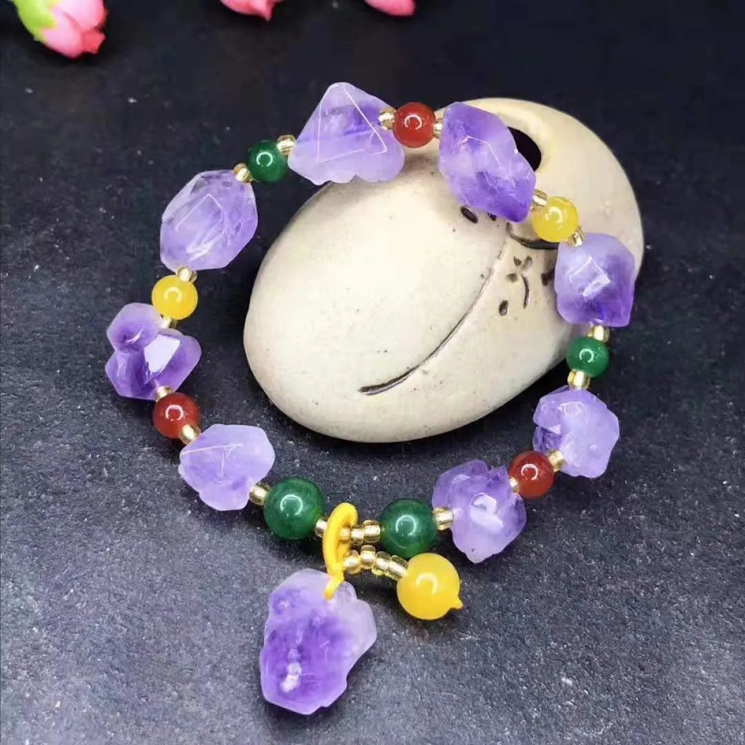 Women's natural amethyst bracelet with a fu character engraved on the central bead.