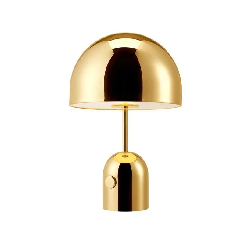 Mushroom-shaped table lamp with metal base in rose gold finish on wooden surface