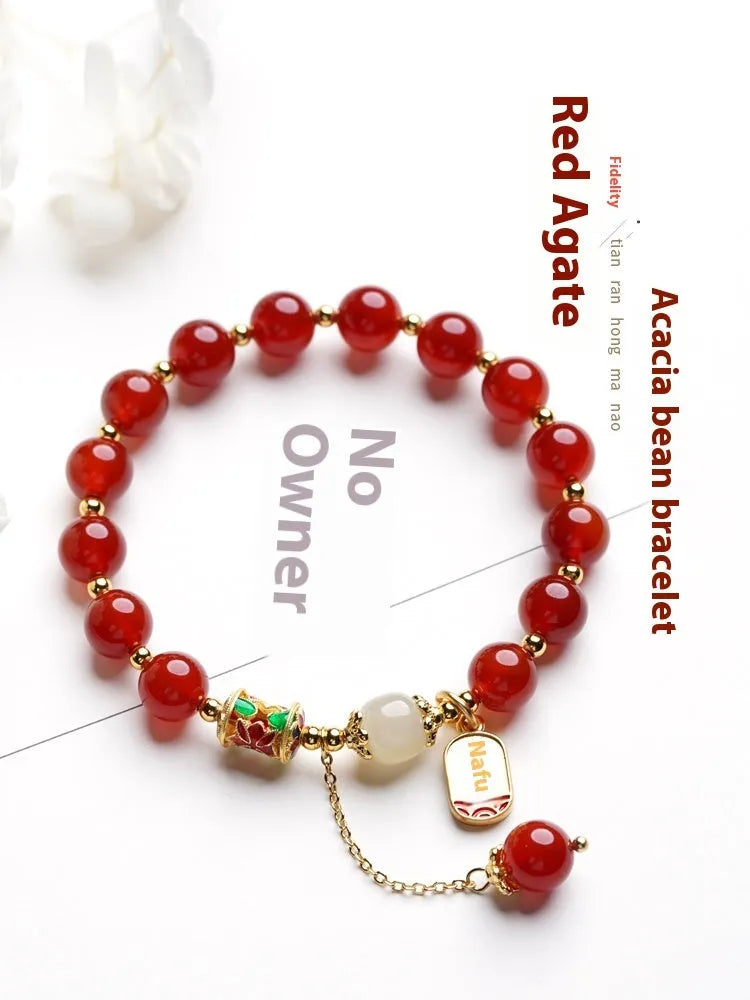 Gold-plated women's bracelet with red agate and Hetian jade beads in a traditional pattern.