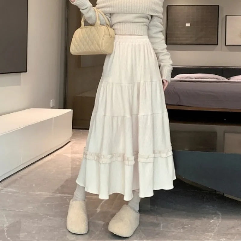 Women's solid colour corduroy A-line midi skirt with elastic waistband in milky white.