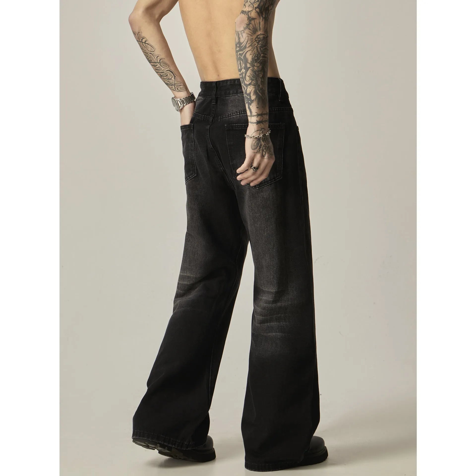 Black loose straight leg jeans with retro styling and zipper fly closure