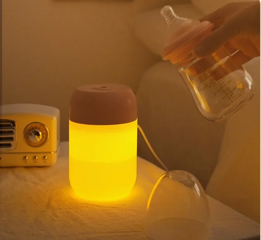 Small white cylindrical USB-powered personal humidifier on a desk.