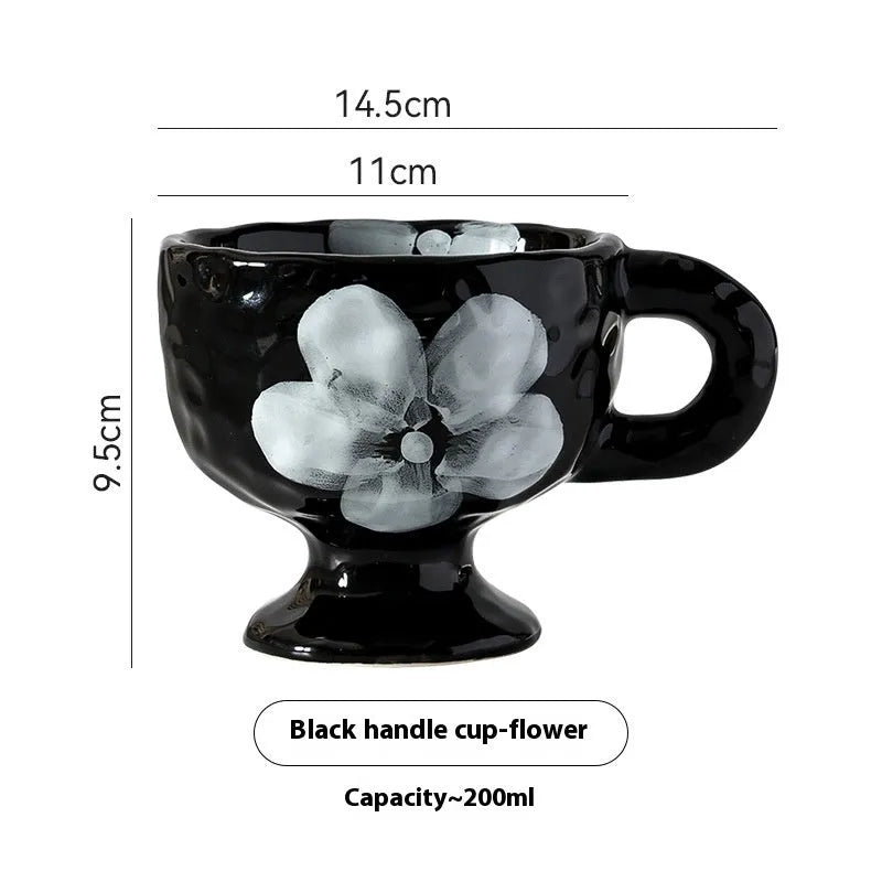 Handmade irregular-shaped ceramic mug in a solid colour glaze, shown on a plain background.