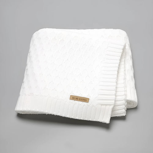 Solid colour baby blanket with textured three-dimensional lines, shown in beige khaki.