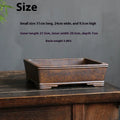 Large rectangular purple sand bonsai pot with firewood burning decoration on a floor.