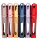 Slender 12ml aluminium portable perfume atomiser in six colours with a glass liner, shown next to a ruler indicating its 115mm height.