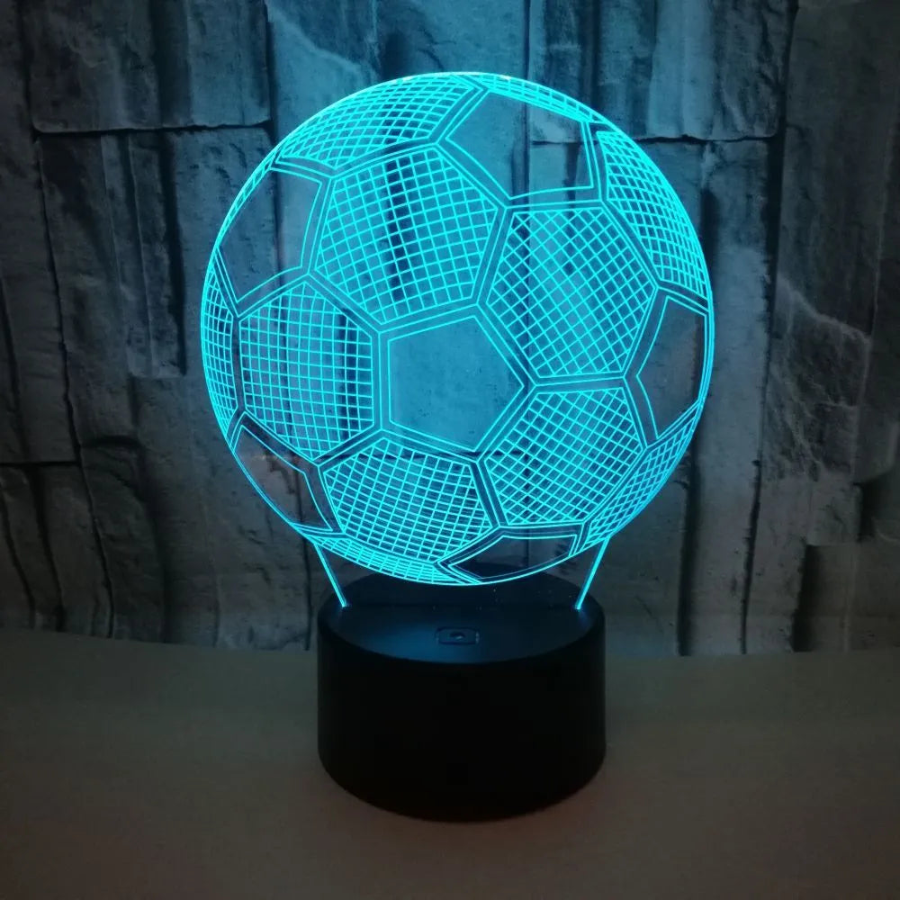 3D football-shaped LED night light on a black base showing multi-colour gradient illumination.