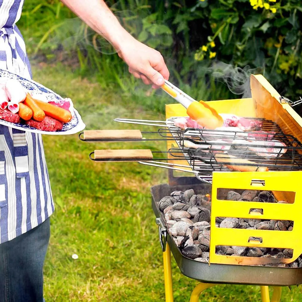 BBQ grill mesh basket with rotary lid and long wood handle placed on a metal grill outdoors