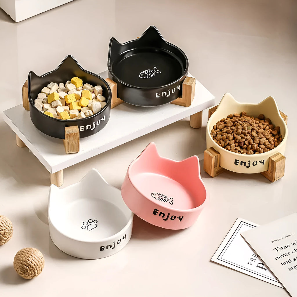 Porcelain cat bowl with cat ear and paw design on a wooden feeding frame, in pink colour.