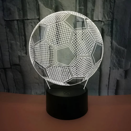 3D football-shaped LED night light on a black base showing multi-colour gradient illumination.