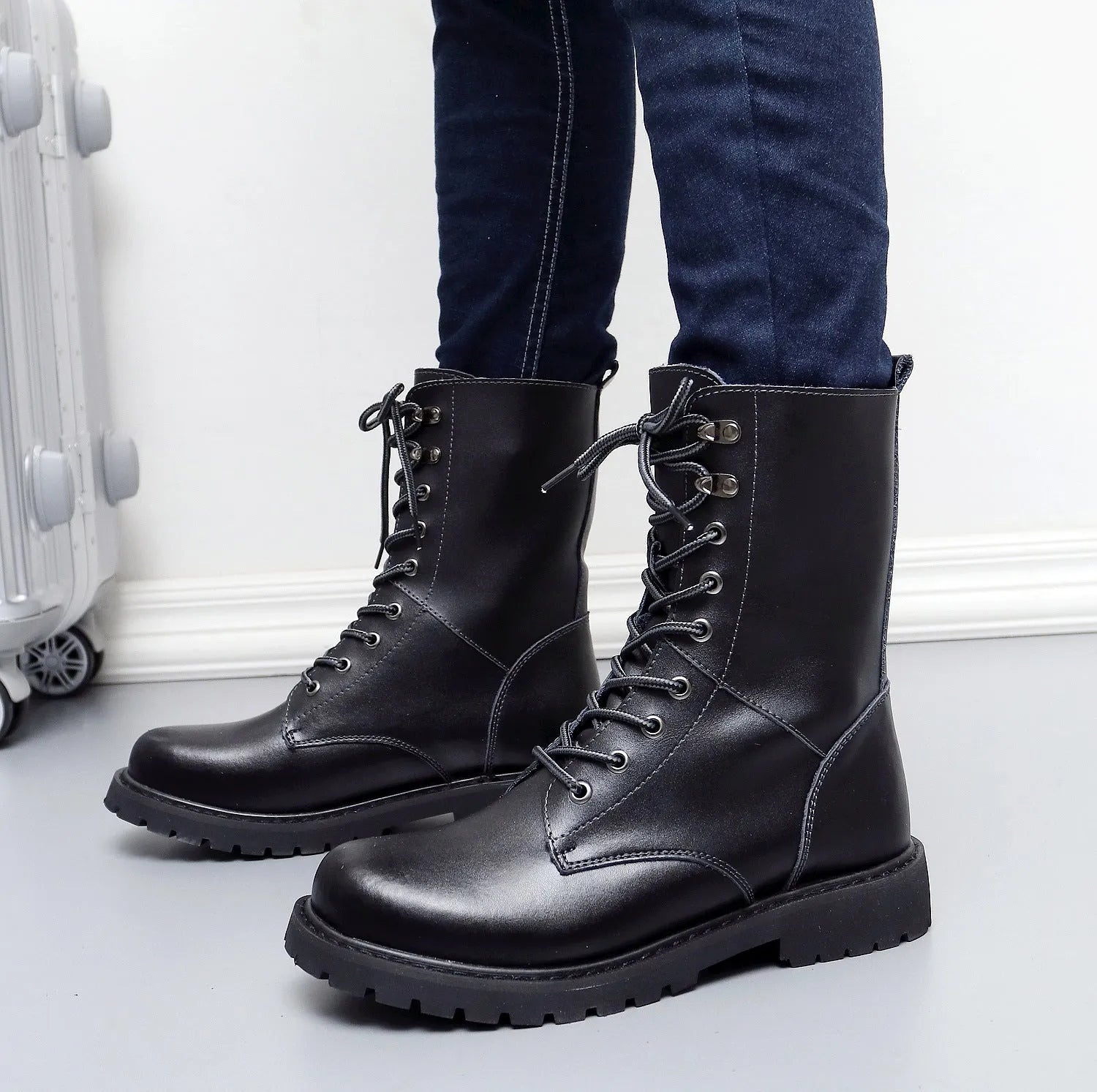 Men's leather military high top boots with fleece lining, black, side view showing front tie closure and square heel