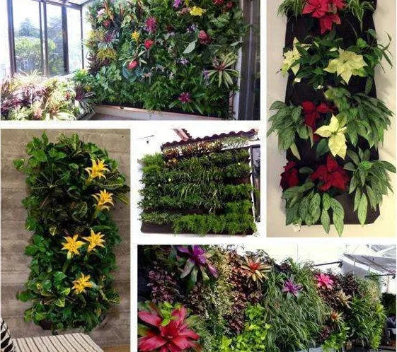 Green felt vertical wall garden planter with multiple planting pockets hung on an outdoor fence.
