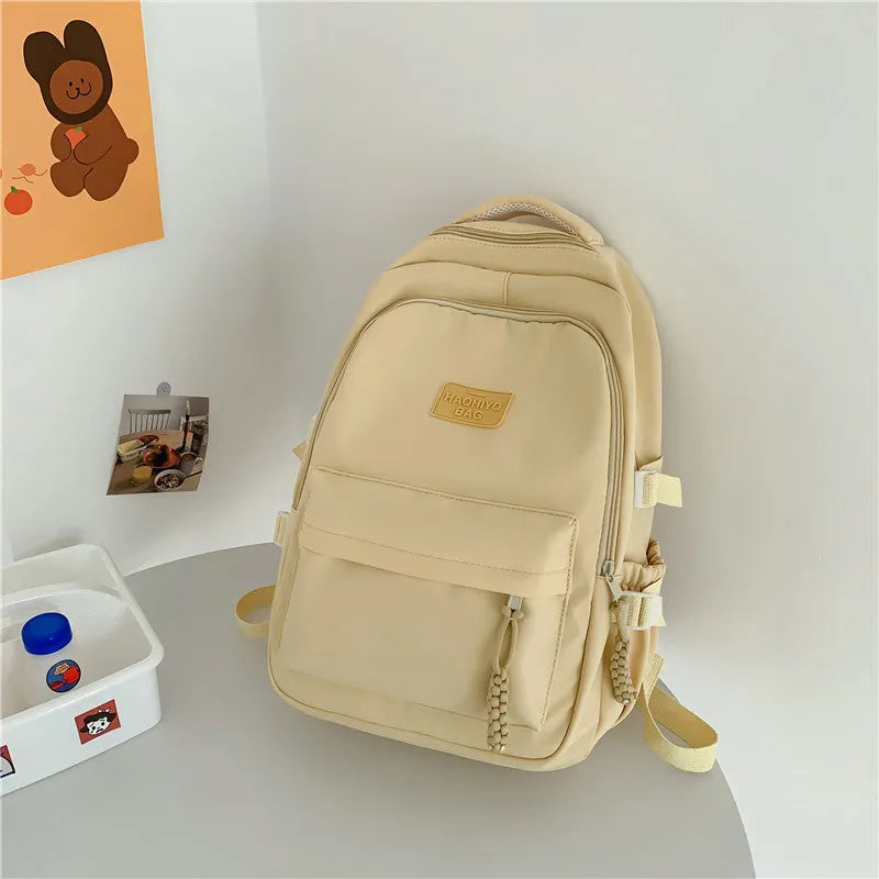 Korean-style lightweight nylon waterproof school backpack in beige with curved shoulder strap