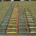 PP jump ladder in black laid flat on grass for foot basket training