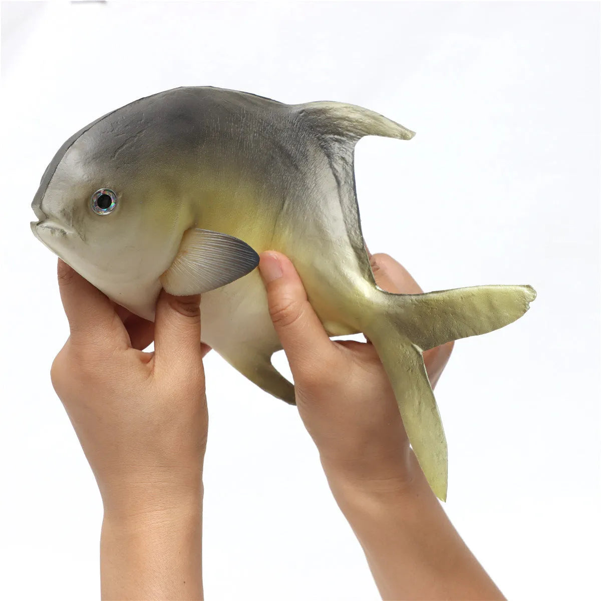Detailed PU simulated fish ornament in yellow-fin tuna colour on a plain background.