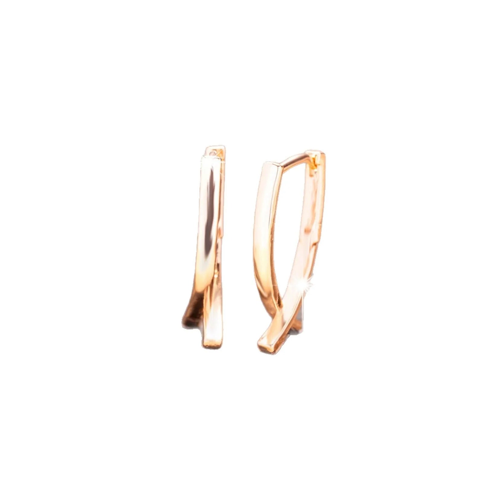 A pair of rose gold cross-shaped earrings made from copper.