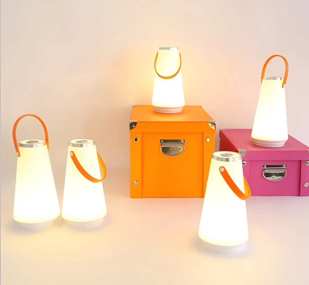 White rechargeable LED bedside lamp with adjustable brightness on wooden table