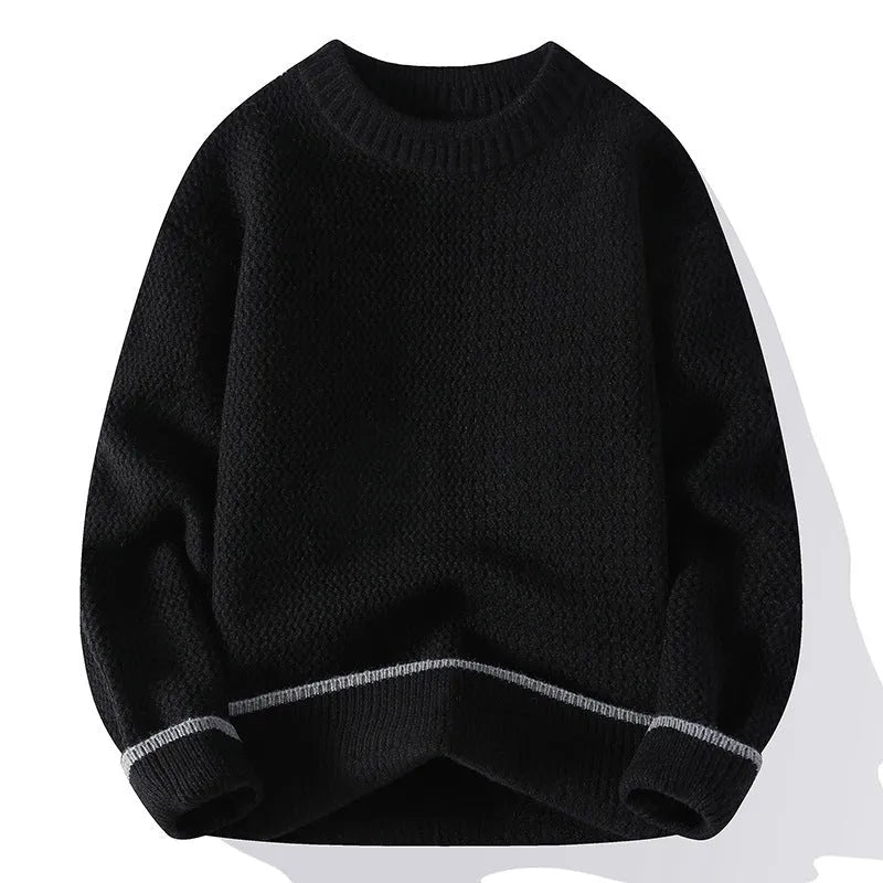 A man wearing a grey loose-fitting round neck casual pullover sweater.