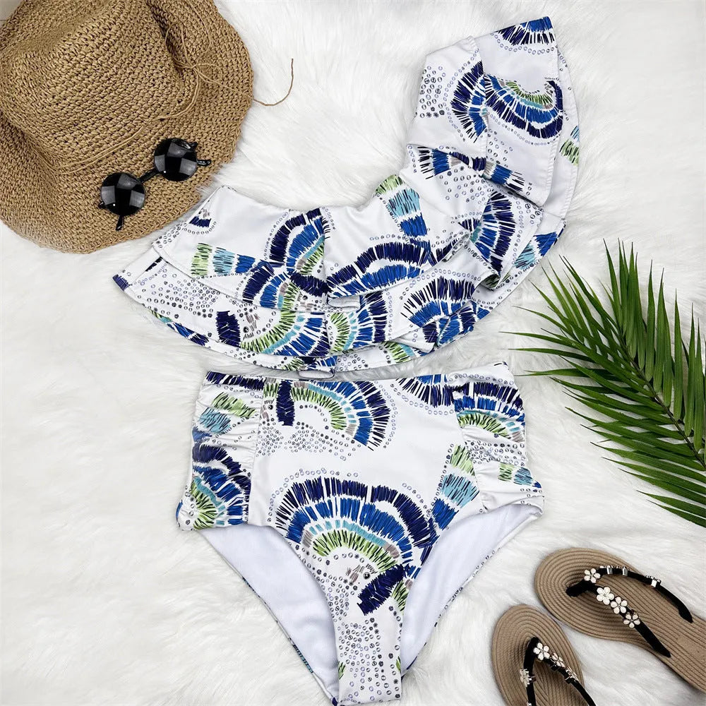 Women's white one-shoulder swimsuit with lotus leaf design and side split detail.