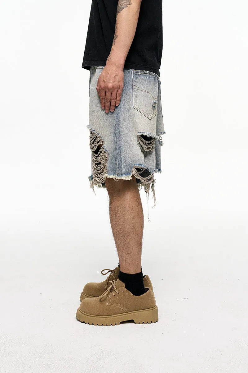 Light blue washed denim shorts for men with a baggy fit and mid waist, shown on a hanger.