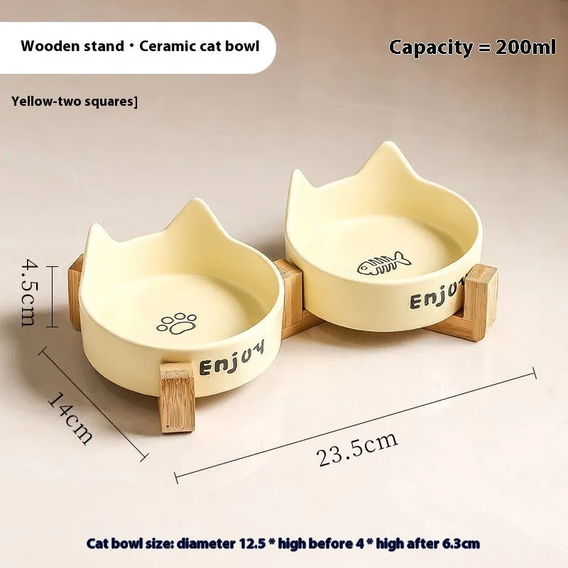 Porcelain cat bowl with cat ear and paw design on a wooden feeding frame, in pink colour.
